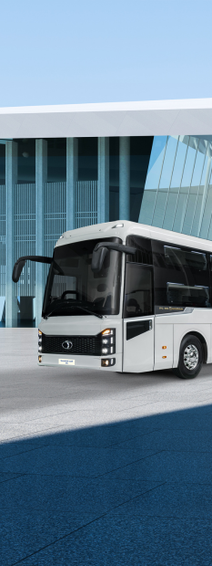 A white bus parked in front of a building