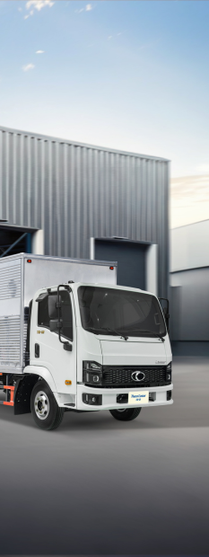 A white truck parked in front of a building