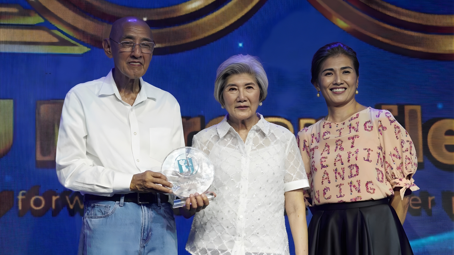Jimmy and Belen Lim, with Leilani Lim-Tan, holding an award