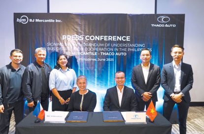 A group of people poses for a photo at a press conference