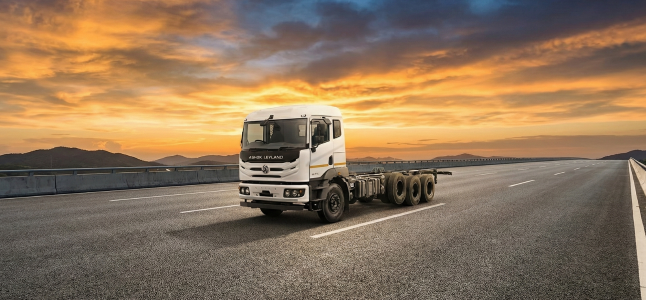 A white Ashok Leyland truck on a sunset background